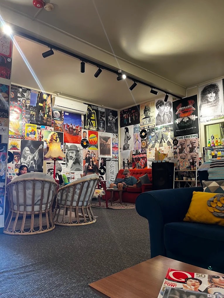 The Blackbird Records lounge, with cane chairs, couches and walls of music posters